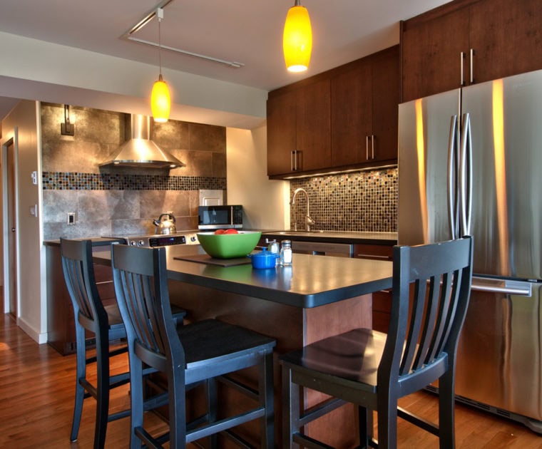 wooden floors black chairs stainless steel refrigerator