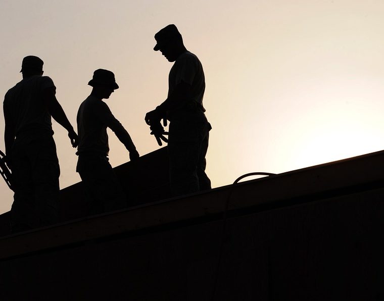 silhouettes of men working
