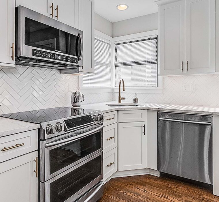 Little country kitchen renovation in Seattle with white cabinets and updated lighting